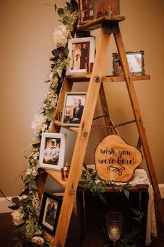 a wooden ladder with pictures and flowers on it