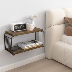 two shelves on the wall next to a bed with books and a radio in it