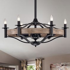 a chandelier with five lights hanging from it's center and wooden planks on the bottom