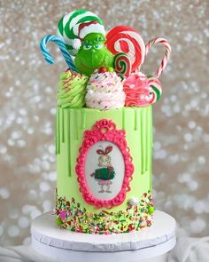 a green cake decorated with candy and candies