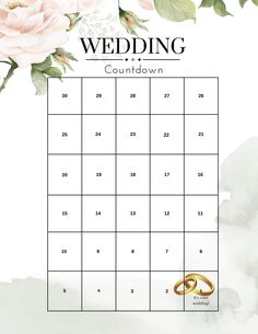 a wedding calendar with two gold rings on it and flowers in the background, as well as