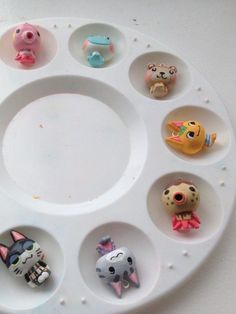 a white tray with twelve different animal figurines arranged in the shape of a circle