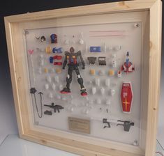 a display case with various toy action figures and toys in it's glass frame