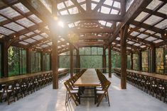 an outdoor dining area with tables and chairs in the sun shining through the roofing