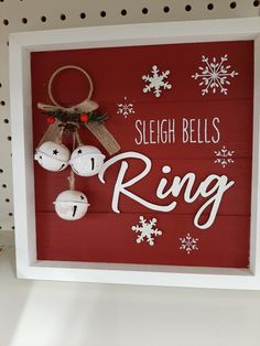 a sign that says sleigh bells ring with ornaments hanging from the front and side