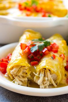 an enchilada on a plate with salsa in the background