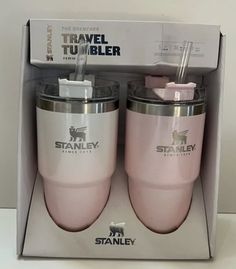 two pink travel tumblers are in the box