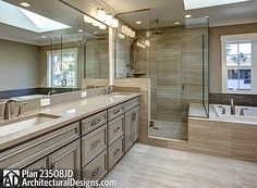 a large bathroom with two sinks and a walk in shower next to a bathtub