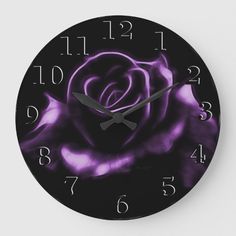 a black and purple clock with a rose on it