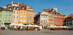 many different colored buildings with white umbrellas