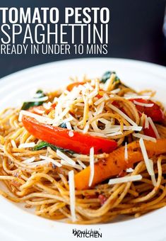 a white plate topped with spaghetti and veggies