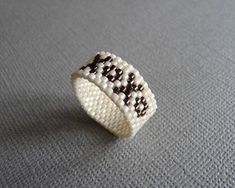 Custom Delica, (tiny even size glass seed bead,) ring with  XoXo, hugs and kisses design. Ring is hand woven off-loom using the peyote stitch . Colors are Cream with Metallic Chocolate or you may choose a custom color combination. To choose custom colors, select the 'Custom' option from the drop down menu and type your desired colors in the 'Note to Seller' box at checkout. I make each ring to order, so each ring is unique!  Band width = 9mm More beaded rings: http://www.etsy.com/shop/SoukySuz/s Ring Pattern, Beautiful Beaded Jewelry, Earring Pins, Beadwork Designs, Custom Candy, Beads Pictures, Beautiful Beadwork, Beaded Ring, Bead Loom Bracelets