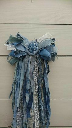 an old pair of jeans tied to a wall with a bow on the front and side