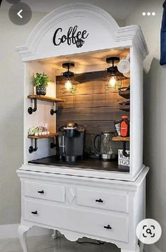 the coffee bar is built into an old dresser and has lights on it's sides