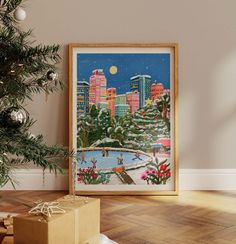 a christmas tree with presents under it in front of a cityscape print on the wall