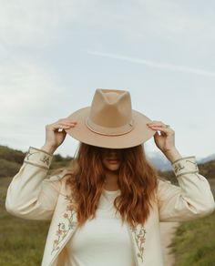 A flat brimmed felt fedora accented by camel grosgrain ribbon, leather bolo cord and gold Freya pin with chains. hat size: 57 cm Luxury Adjustable Gold Fedora, Luxury Gold Fedora With Short Brim, Luxury Beige Fedora Felt Hat, Luxury Beige Fedora With Flat Crown, Luxury Beige Fur Felt Fedora, Felt Fedora, Fedora Hat, Hat Sizes, Grosgrain Ribbon