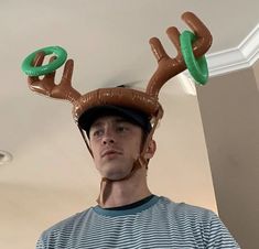 a man wearing an inflatable deer hat