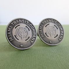 An attractive pair of cuff links that I made with original vintage Miami transit tokens.  They are silver tone and have silver tone backs encased in a two-part epoxy.  A little larger than average at 7/8" in diameter.  They will come in a new gift box and this will be the exact pair you will receive.  If you need more than one pair, please let me know.  I also have other Miami token jewelry in my shop:www.etsy.com/shop/lucra?ref=shop_sugg&search_query=miamiI can usually fill larger orders bu Vintage Collectible Cufflinks, Vintage Miami, Repurposed Vintage, Tie Tack, Coin Jewelry, Tie Accessories, Upcycled Vintage, Cuff Links, Lapel Pins