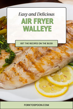 an air fryer grilled fish with lemons and broccoli on the side