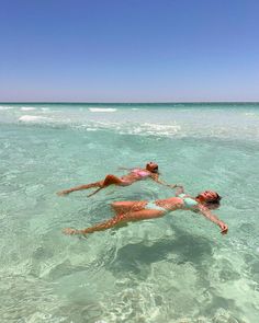 two people are swimming in the ocean together