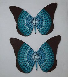 two blue and black butterflies sitting on top of each other