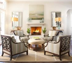 a living room filled with furniture and a fire place in the middle of the room