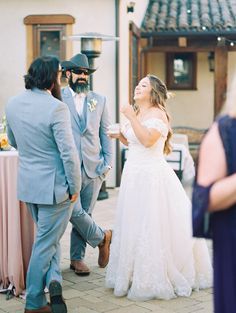 a bride and groom are laughing at each other