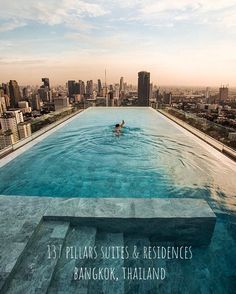 an empty swimming pool in front of a city skyline