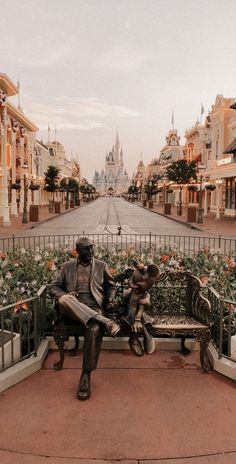 a statue sitting on top of a bench next to a street