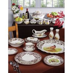 a dining room table set with dishes and utensils