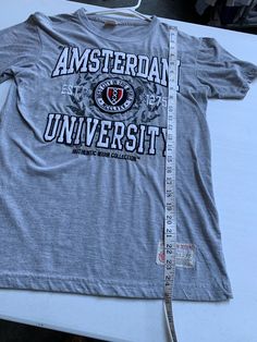 Vintage Amsterdam University T Shirt Size Small See pics for measurements Awesome Stitched Letters & Logo EUC Excellent Condition Classic Gray Fast shipping. We ship same or next day with USPS We are a small family business and we appreciate your support, Godspeed ! Gray Collegiate Short Sleeve Top, Fitted Cotton Collegiate T-shirt, Gray Short Sleeve Collegiate Top, Stitched Letters, Letters Logo, University Tshirt, Felt Letters, Classic Gray, Champion Brand