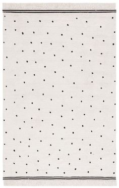 a white rug with black dots on it