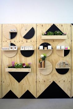 several wooden shelves with plants and flowers on them