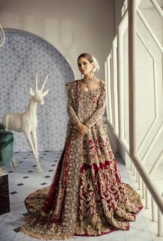 a woman in a red and gold wedding dress