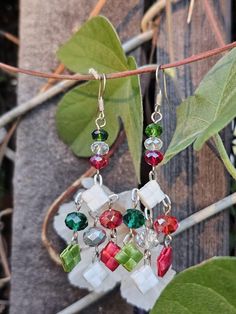 About These Earrings Celebrate Mexican Independence Day with these lightweight tricolor earrings! The red, green, and white represent the colors of the Mexican flag. September 16th marks the day my beautiful country of Mexico became its own nation, and it's celebrated annually with colorful parades and fiestas every year all across Mexico and even in the US.  Length: 2.75 inches Width: 1.25 inches Materials: crystal beads, woven plastic About Me My name is Esther and I make statement jewelry that is inspired by my Mexican heritage and a commitment to sustainability. I use a mix of traditional materials, like precious and semiprecious stones, and reused or upcycled materials, like paper beads, pieces of wood, materials from unused clothes, and more. You all have in innate beauty, and my goa Handmade Multicolor Earrings For Holiday, Handmade Multicolor Holiday Earrings, Holiday Multicolor Handmade Earrings, Multicolor Earrings For Christmas Gift, Multicolor Dangle Earrings For Holiday, Multicolor Holiday Dangle Earrings, Green Dangle Earrings For Celebration, Green Dangle Crystal Earrings For Festive Occasions, Green Beaded Drop Earrings For Festive Occasions