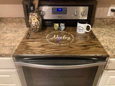 a coffee mug sitting on top of a counter next to an oven with the word medley printed on it