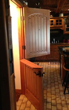 an open door leading into a kitchen with tile flooring