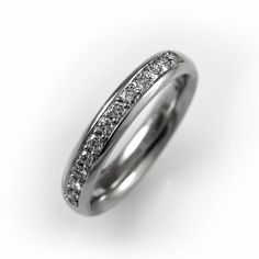 a white gold wedding ring with princess cut diamonds set in the center and channeled sides