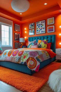 a bedroom with orange walls and colorful bedding in the center is lit by recessed lights