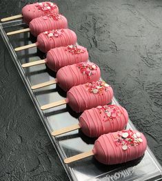 a row of pink donuts with sprinkles on them