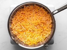 a pot filled with cheese on top of a white counter