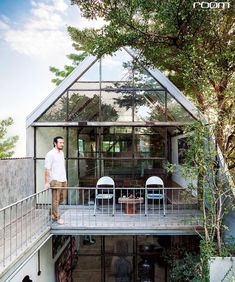 a man standing on the balcony of a house