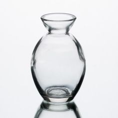 a clear glass vase sitting on top of a table