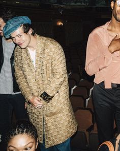 a man wearing a blue bandana standing next to other people