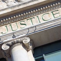 an old building with the word justice written on it's front and side columns