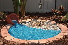 a small pool made out of rocks and pebbles