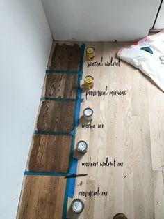 the floor is being laid out with tape on it and some cans next to it