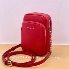 Brand New With Tag Color: Bright Red Crossbody Bag 100% Pebble Leather Gold-Tone Hardware 9"W X 5.5"H X1"D Exterior Details: Back Slip Pocket, Front Zip Pocket Interior Details: Back Slip Pocket, Card Slots Lining: 100% Polyester Zip Fastening Dust Bag Not Included Imported Style # 35f1gtvc2b Michael Kors Mobile Phone Bag, Michael Kors Travel Shoulder Bag With Phone Holder, Michael Kors Shoulder Bag For Travel With Phone Bag, Red Phone Bag With Detachable Strap, Michael Kors Crossbody Shoulder Bag With Mobile Phone Bag, Michael Kors Shoulder Bag With Mobile Phone Bag, Michael Kors Travel Pouch Bag, Michael Kors Crossbody Mobile Phone Bag, Michael Kors Mobile Phone Crossbody Bag