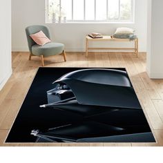 a black area rug with an image of a car on the floor in front of a window