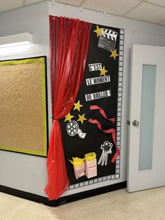 a classroom door decorated with red curtains and decorations